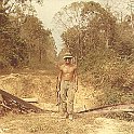 Les Higa with Cambodia in the background.  Road over his shoulder is part of the ole "Ho Chi Minh Trail".